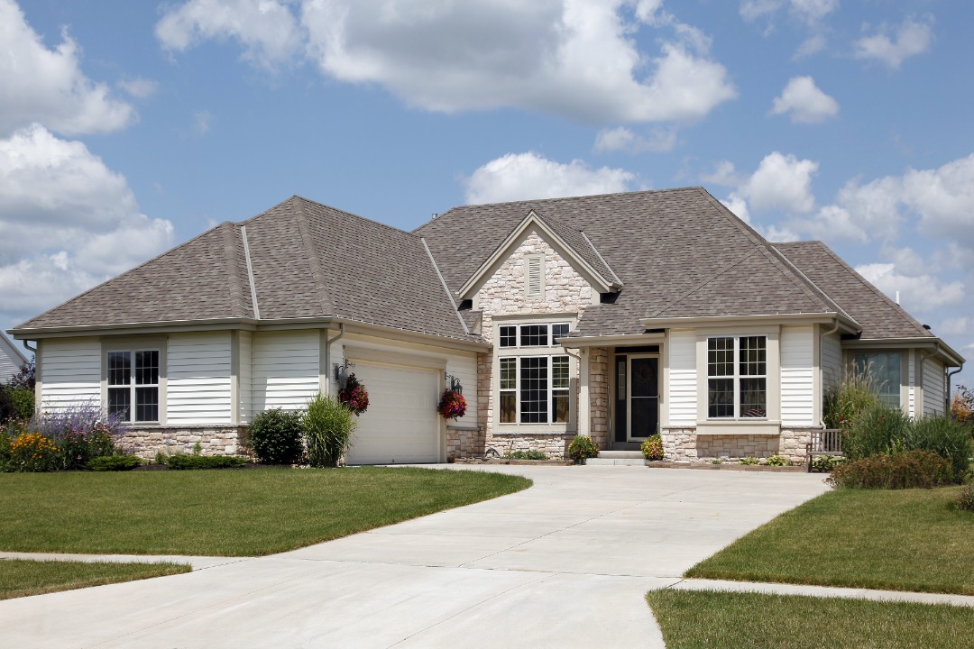 A beautiful house surrounded by a lush, well-maintained lawn.
